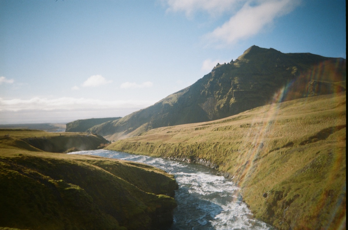 River running through green Icelandic hills